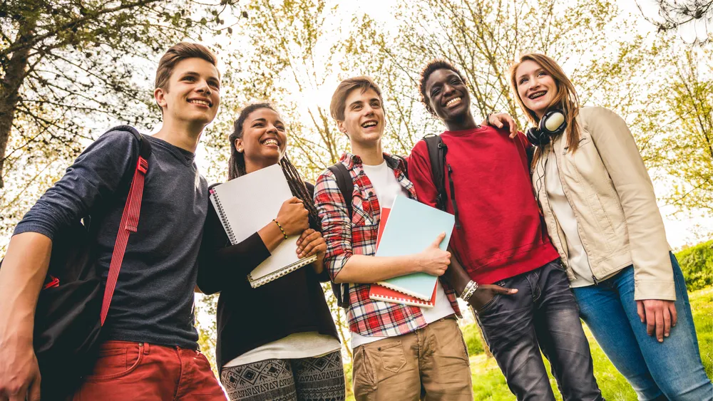 Teenage students together outdoors